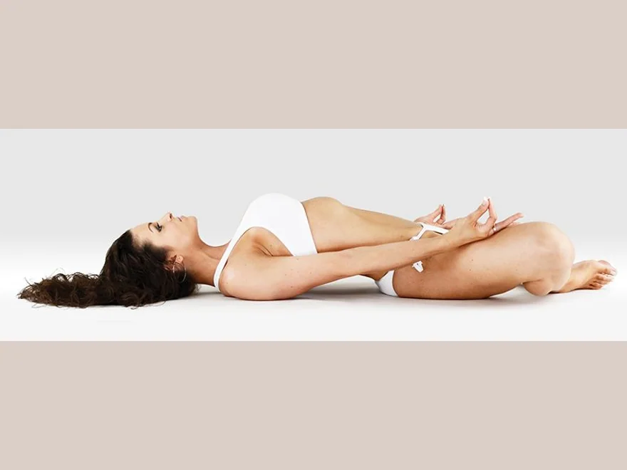 Reclining Bound Angle (Supta Baddha Konasana) — photograph